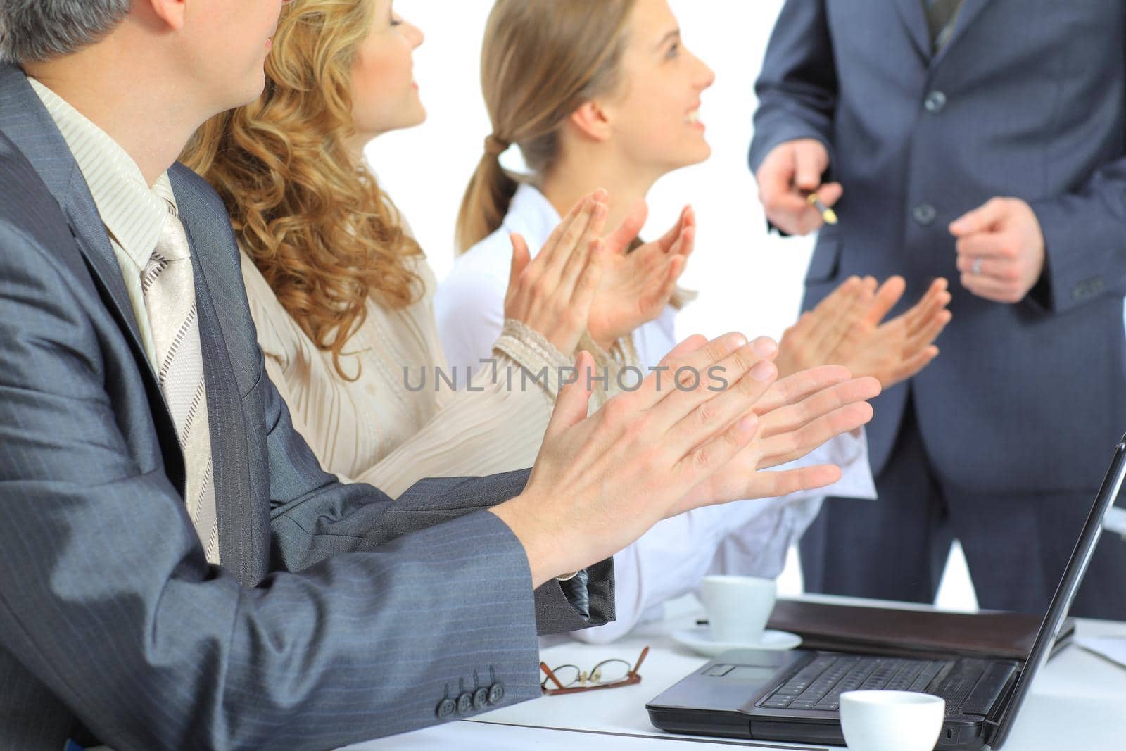 Beautiful businesswoman keeps the laptop. Isolated on a white background.