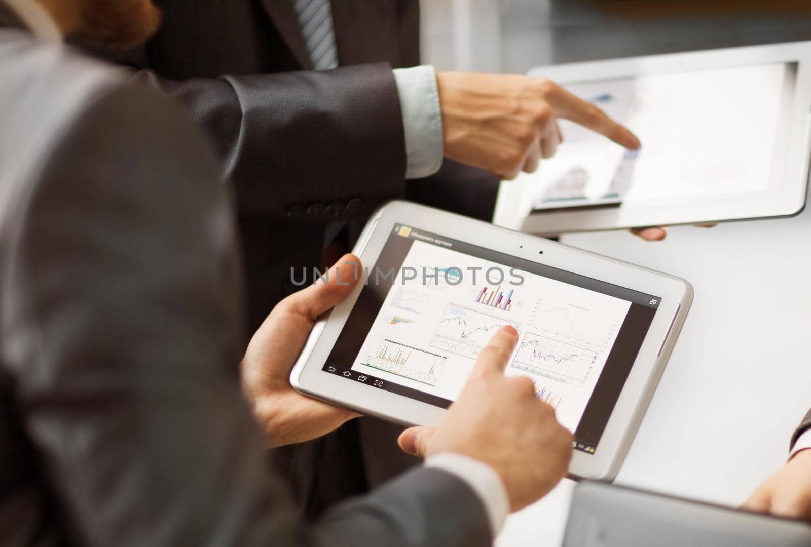 Hands of people working with tablet computer.