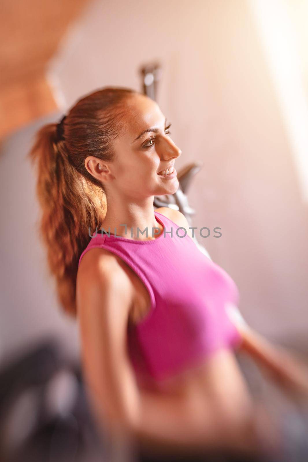 Beautiful young woman doing exercises at her home.