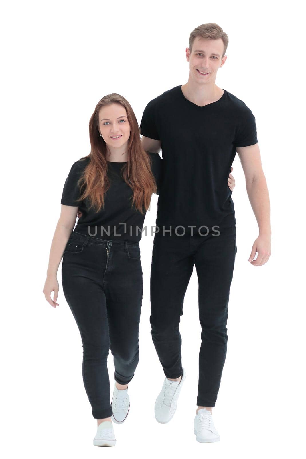 in full growth. casual young couple standing together . isolated on white