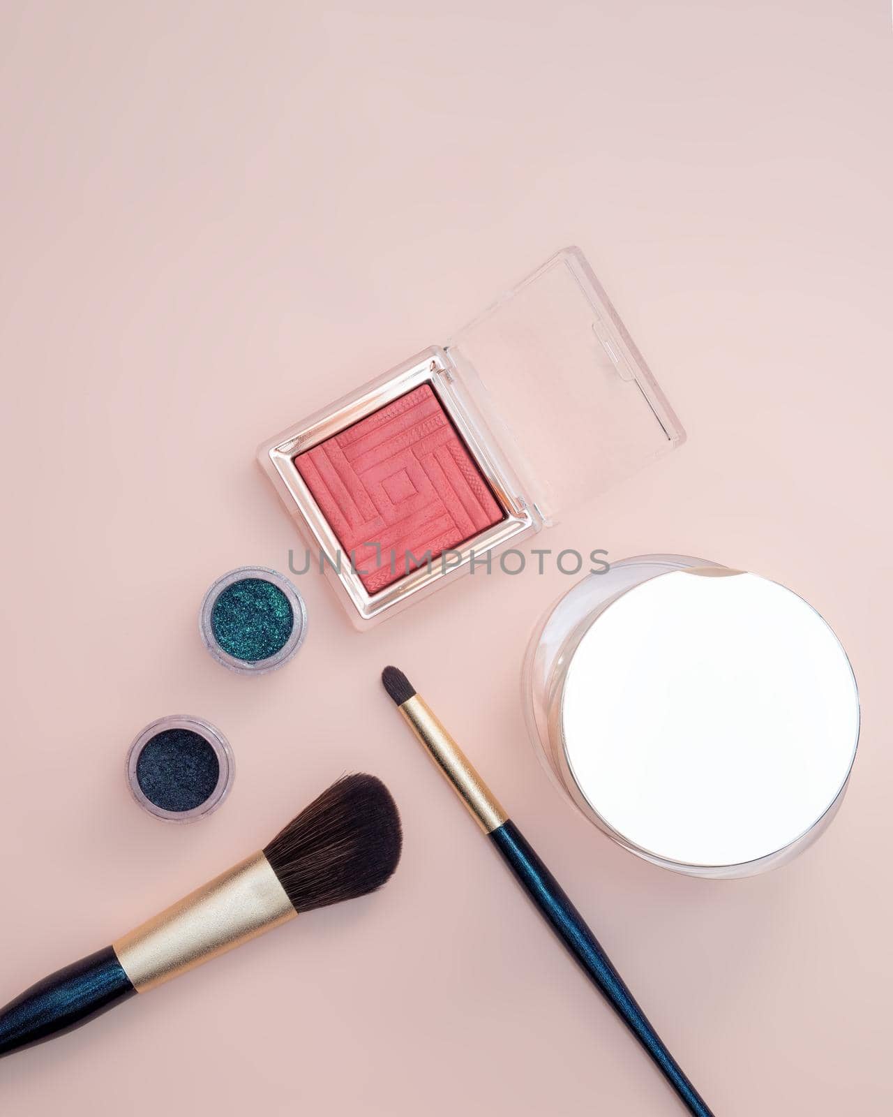Composition with decorative makeup products golden brushes and colorful eye shadows on pastel pink background. by Andre1ns