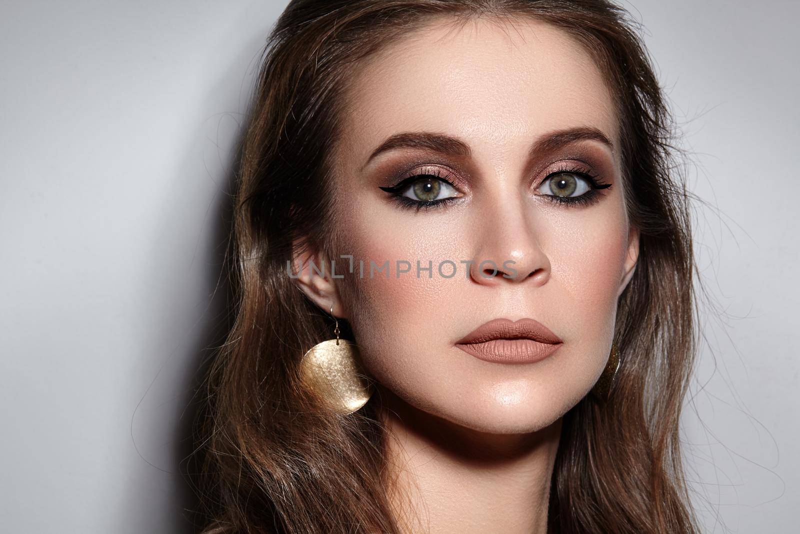 Beautiful Woman with Professional Makeup. Celebrate Style Eye Make-up, Perfect Eyebrows, Shine Skin. Bright Fashion Look.