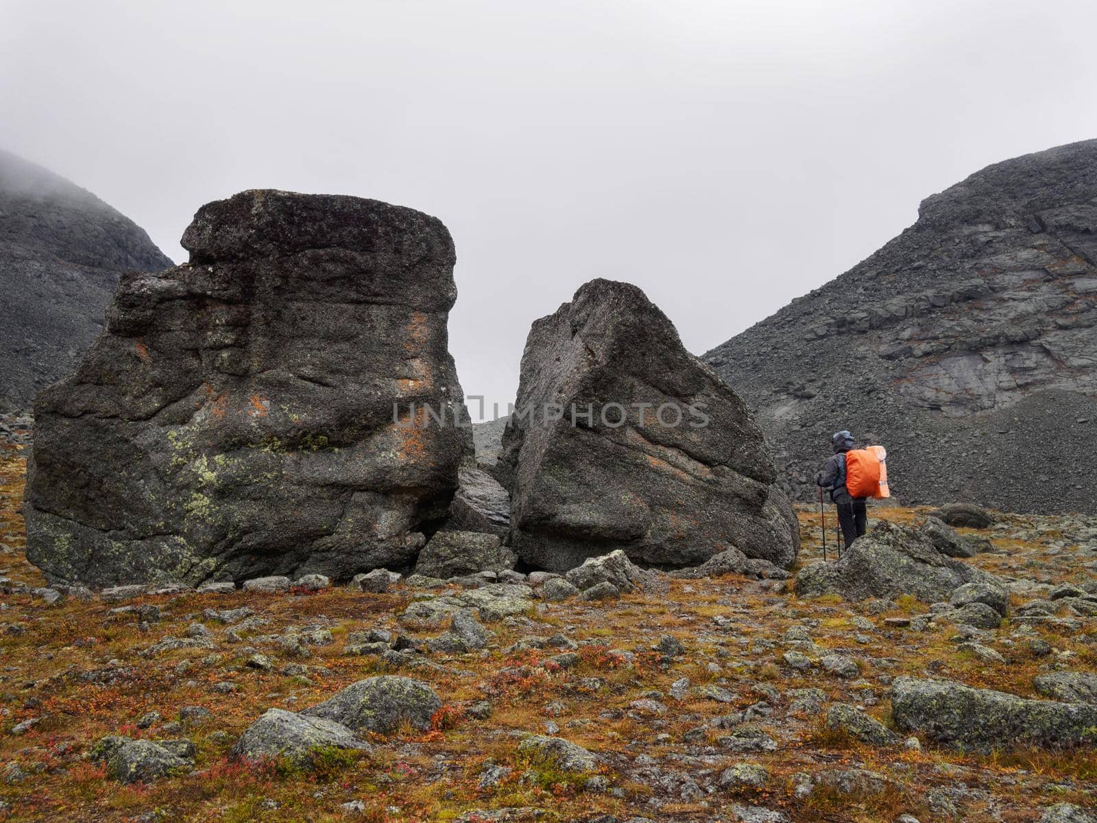 Hiker woman walking in a mountain rocky path. photo