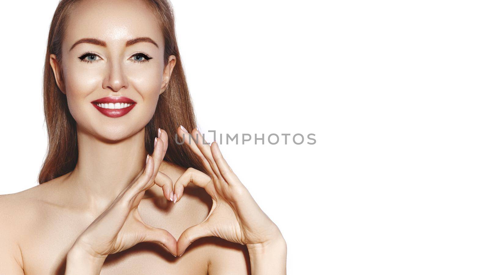Romantic young Woman making Heart Shape with her Fingers. Love and Valentines Day Symbol. Fashion girl with Happy Smile by MarinaFrost