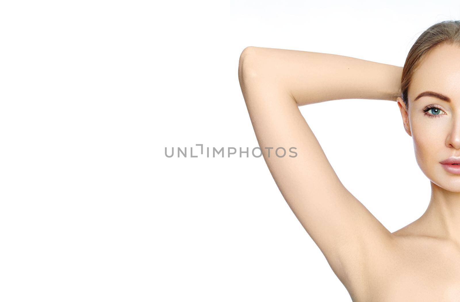 Beautiful woman holding her arms with clean underarms on white background. Epilation smooth skin. Hair removal on arms