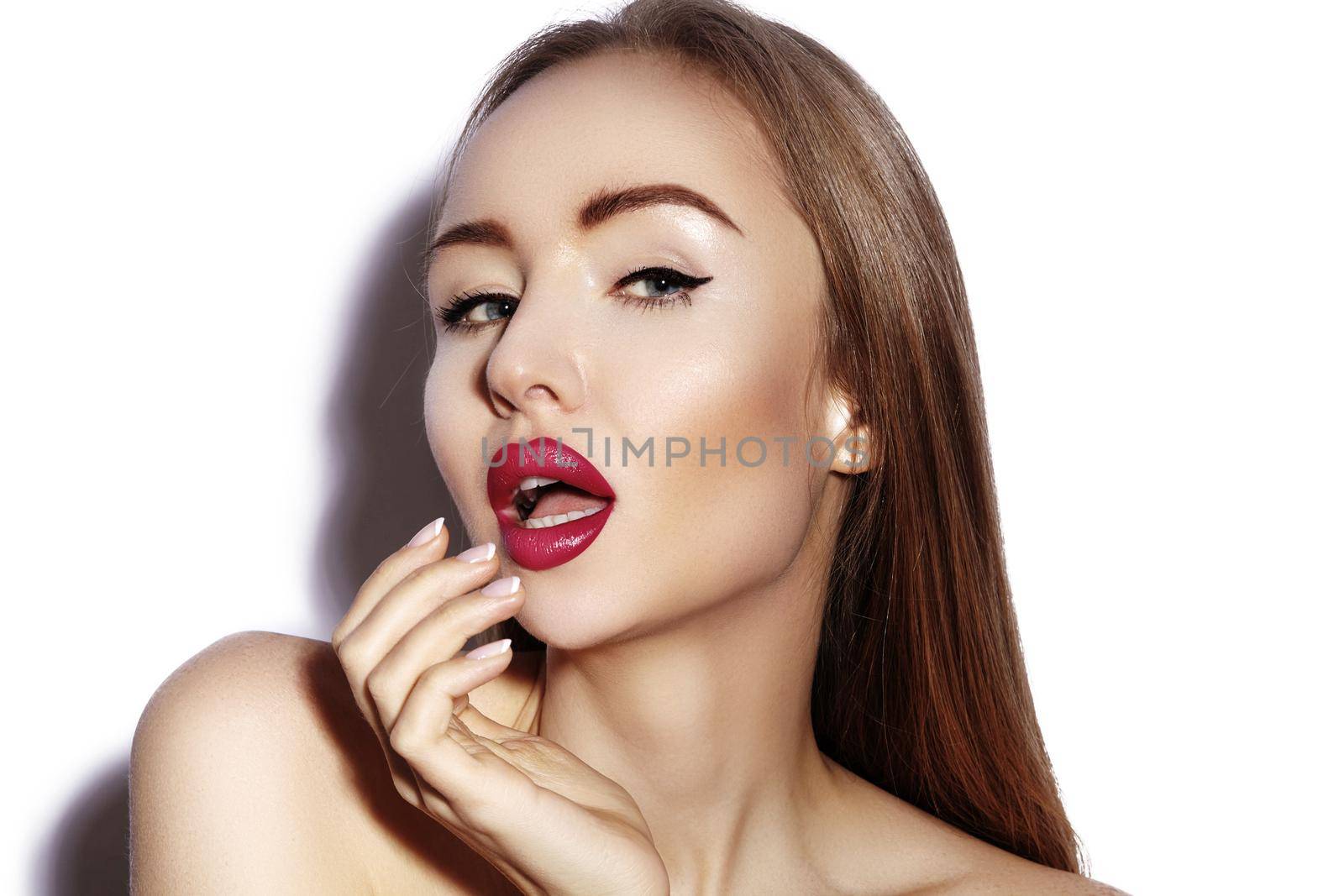 Blow sweet kiss. Beautiful woman with fashion red lips make-up on white background. Valentines day Makeup. Sexy look