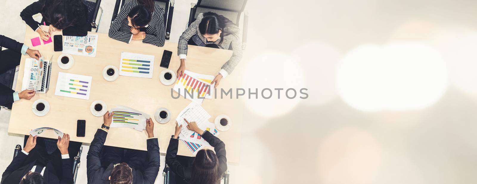 Business people group meeting shot from top view in office . Profession businesswomen, businessmen and office workers working in team conference with project planning document broaden view .