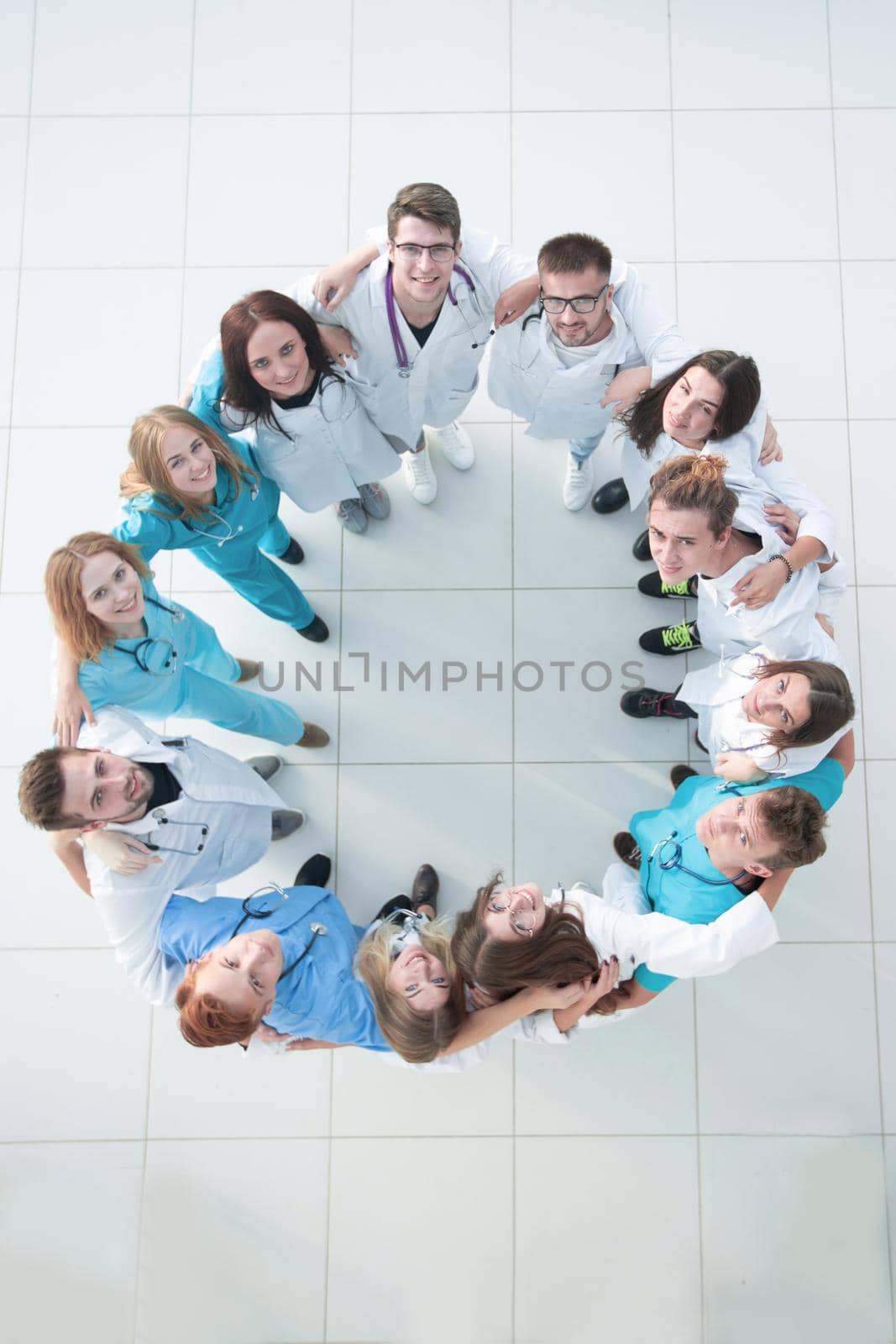 happy woman doctor looking at a group of her colleagues. success concept