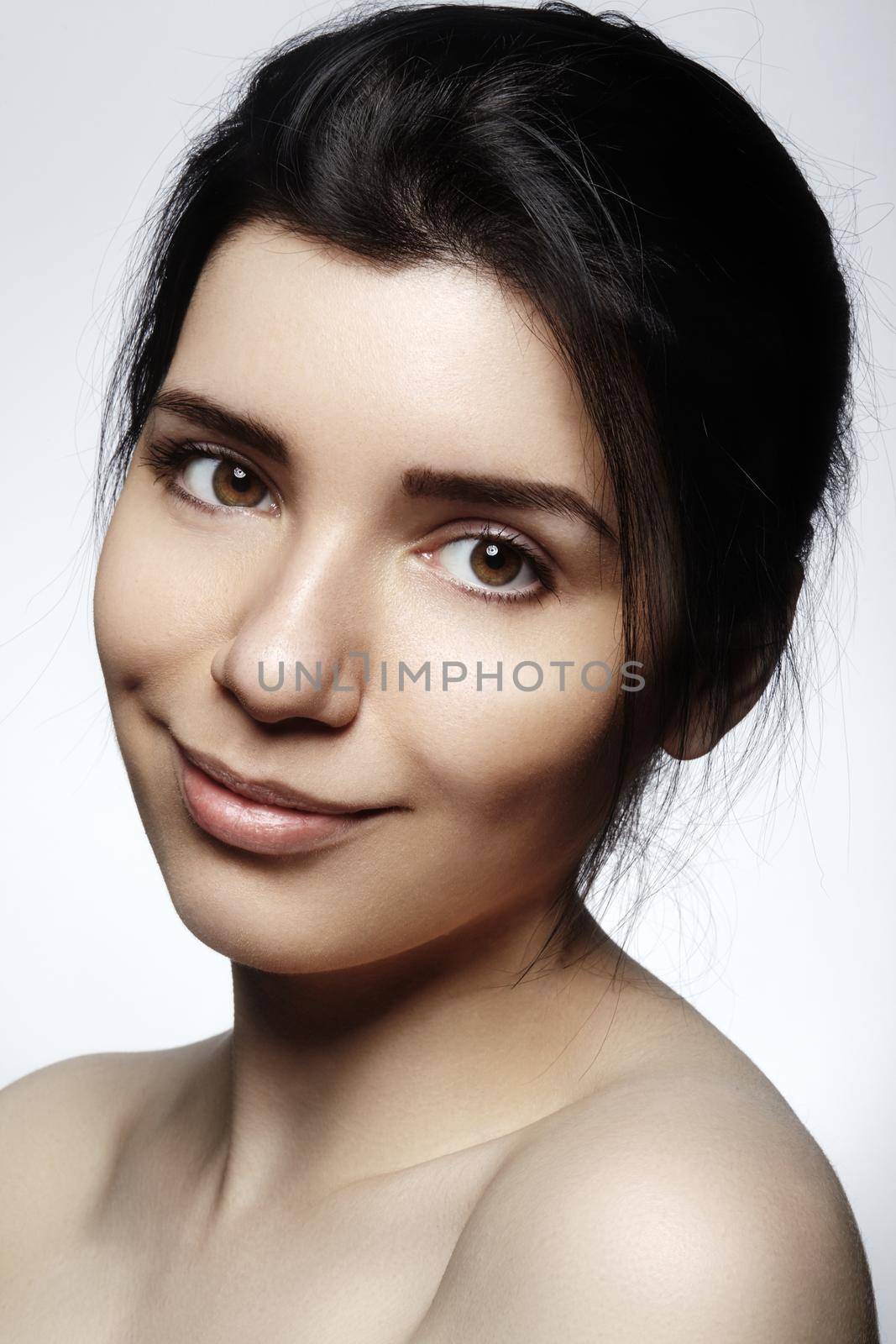 Beautiful face of young woman. Skincare, wellness, spa. Clean soft skin, healthy fresh look. Natural daily makeup.