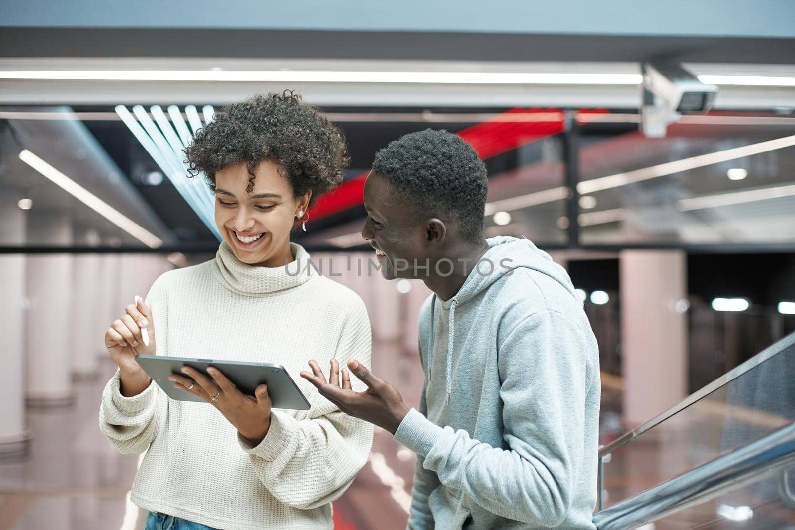 young couple with a digital tablet discussing their route. by SmartPhotoLab