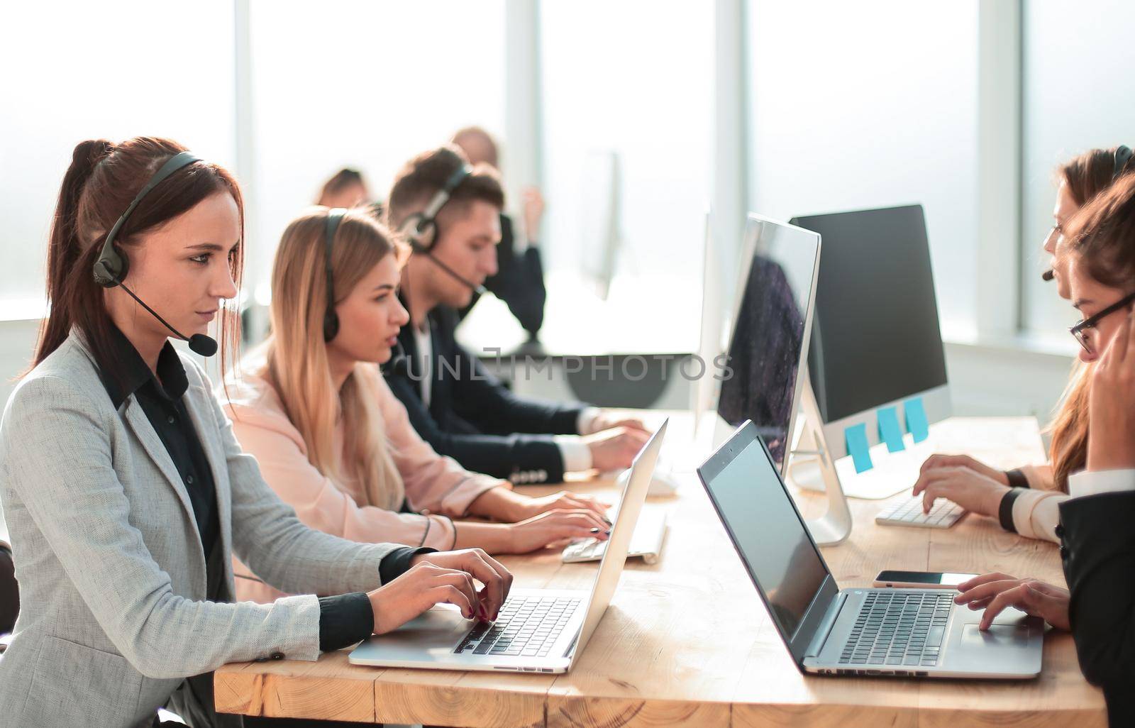 group of employees of the support center at the workplace in the office. photo with copy-space