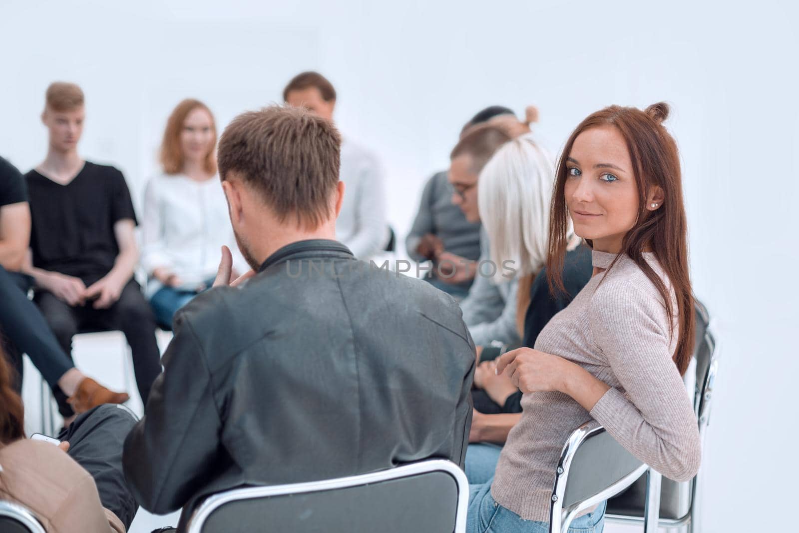 close up. young woman sitting in a circle of her like minded