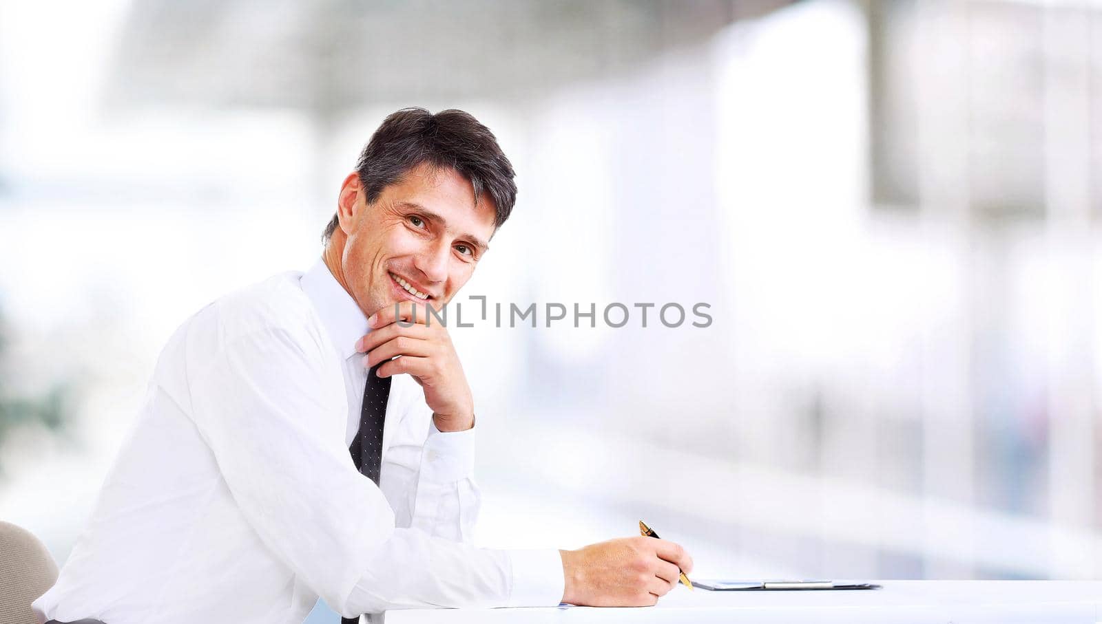 Handsome business man smiling at the office