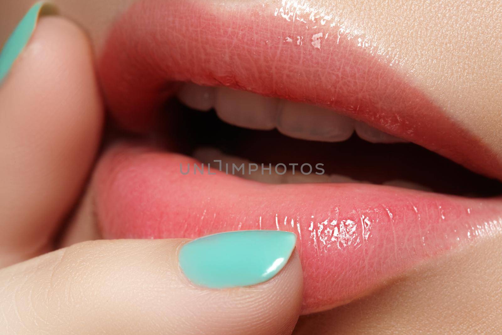 Face part. Beautiful female lips with natural makeup, clean skin. Macro shot of female lip, clean skin. Fresh kiss. Spa beauty cosmetics.