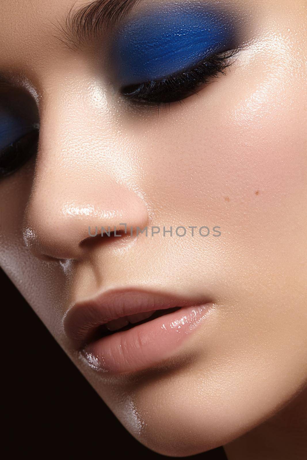 Closeup with of beautiful woman. Fashion makeup, clean shiny skin with highlighter. Makeup and cosmetic. Beauty style by MarinaFrost