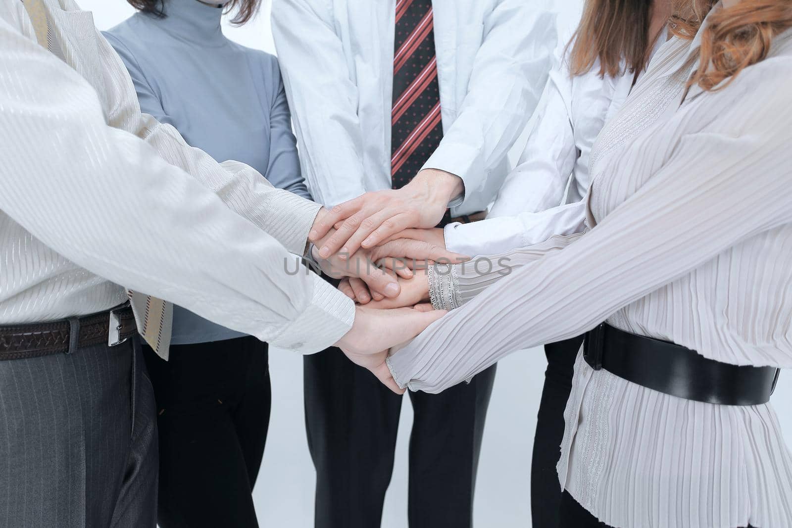 closeup.hands team put together.isolated on a white background.the concept of teamwork