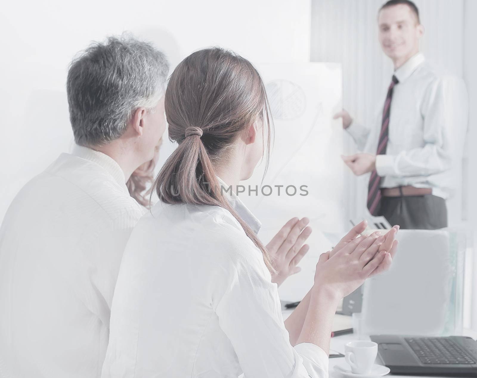 closeup.colleagues applauding the speaker at a business conference