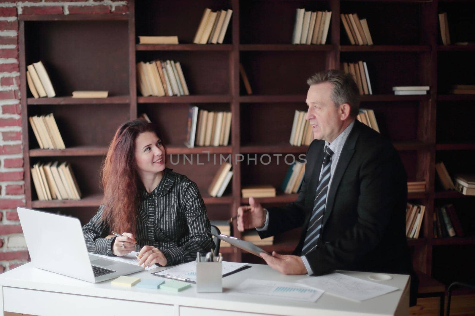 senior businessman and assistant working in a modern office.