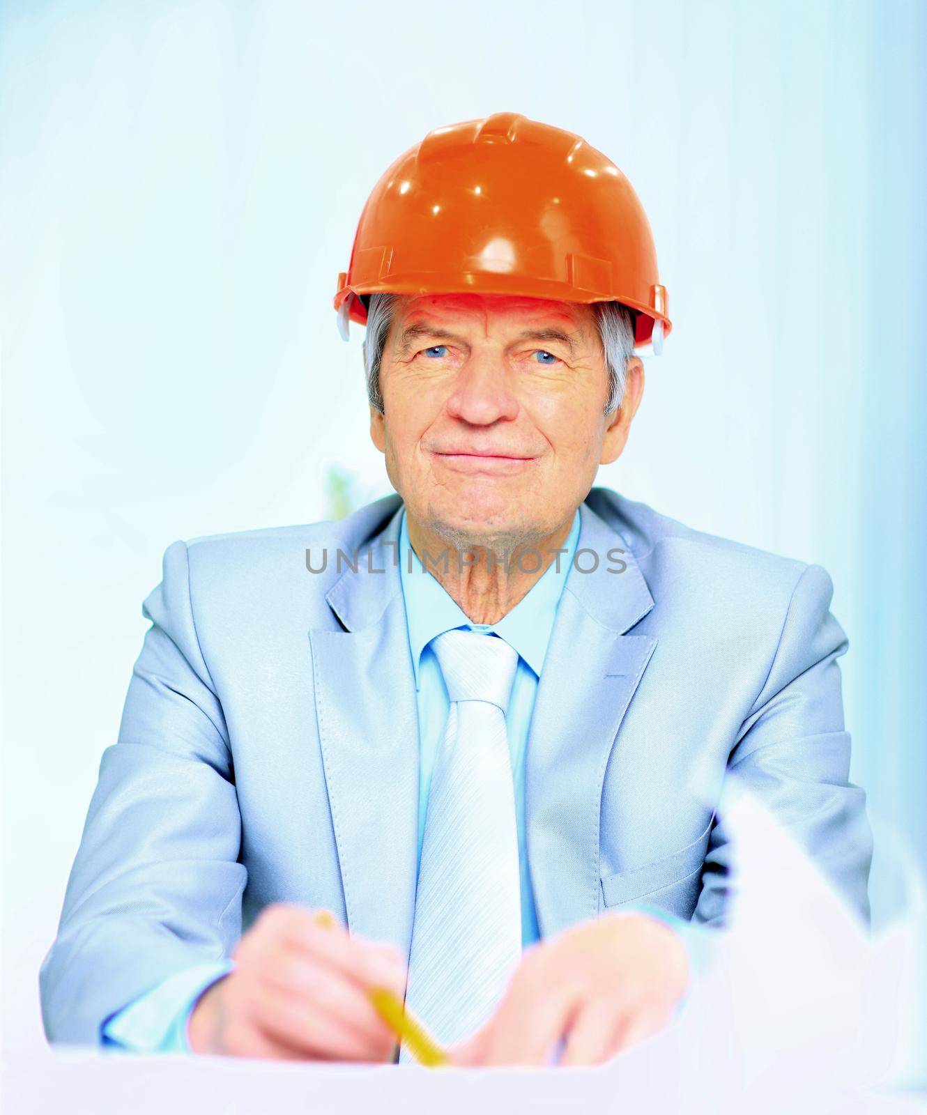 Engineer at the age of considering plans drawing and corrects them.