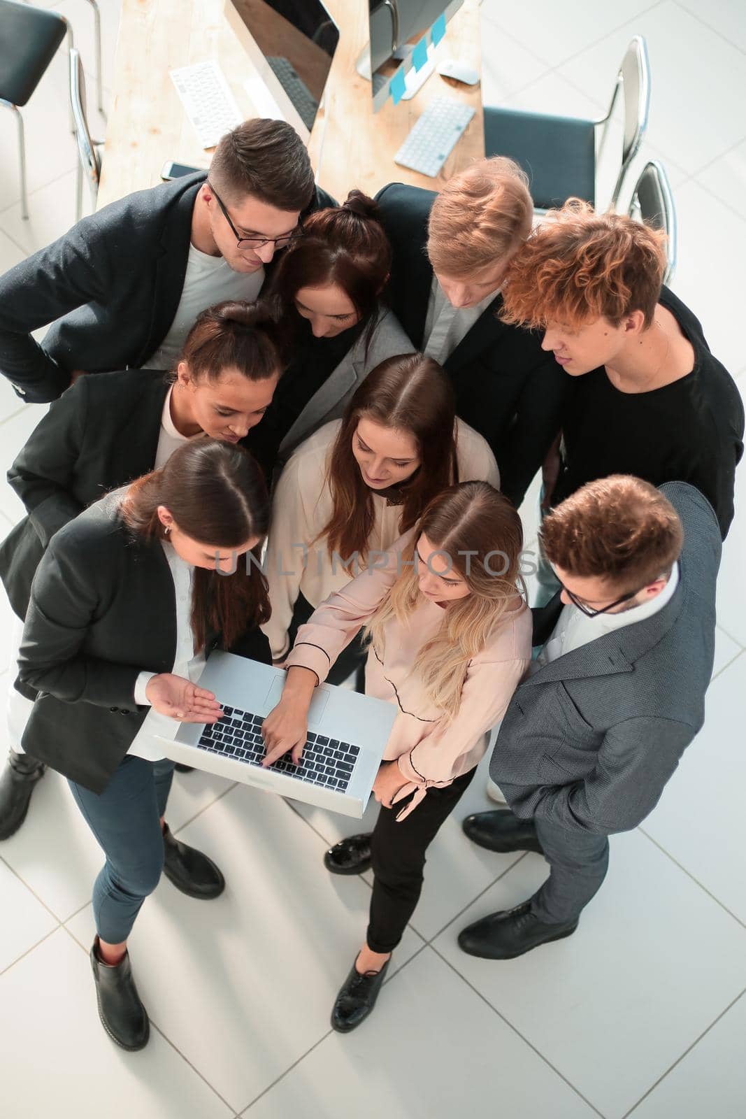 top view. business team together pointing at the laptop screen. by asdf