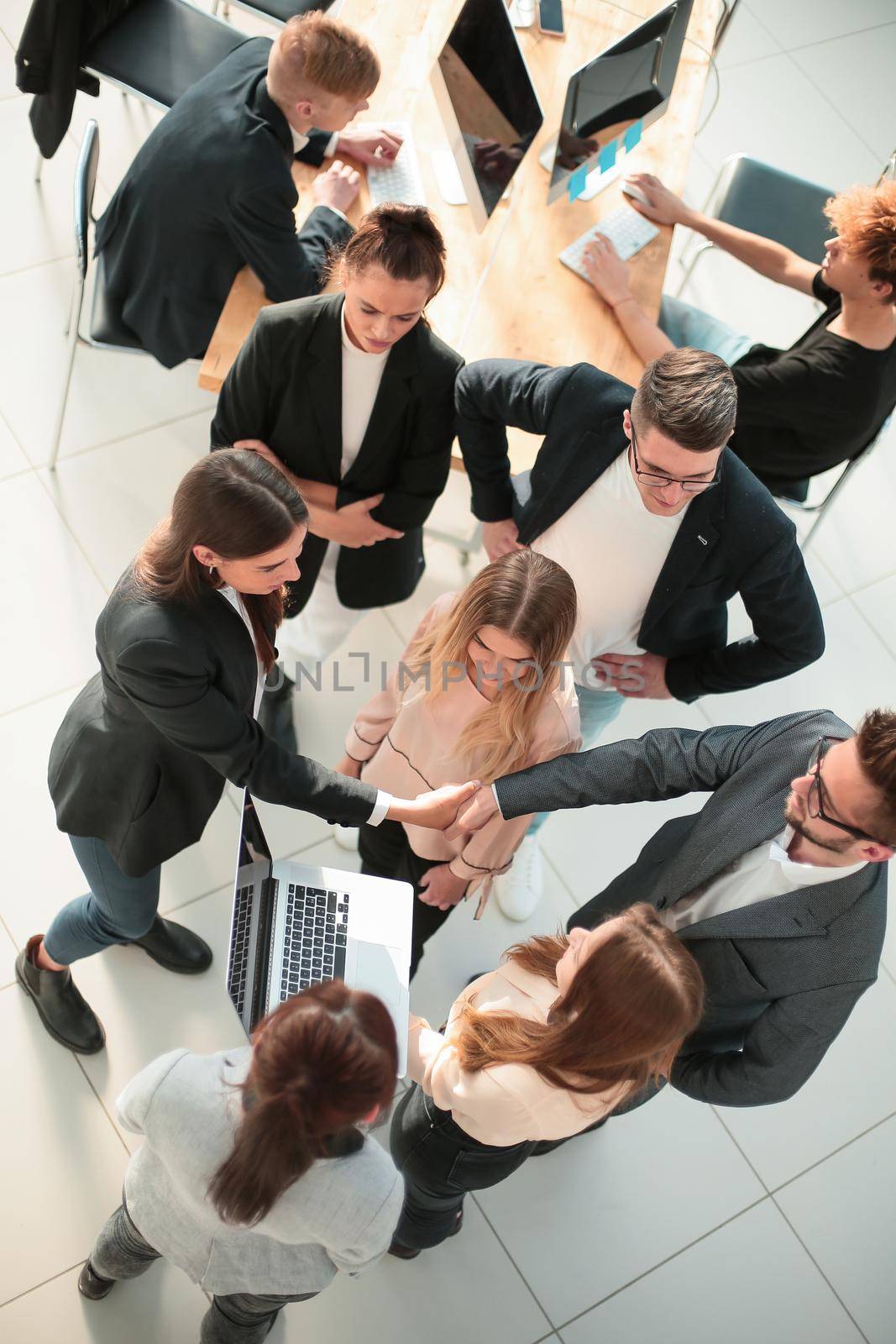 top view. a group of young business people in a modern office. by asdf