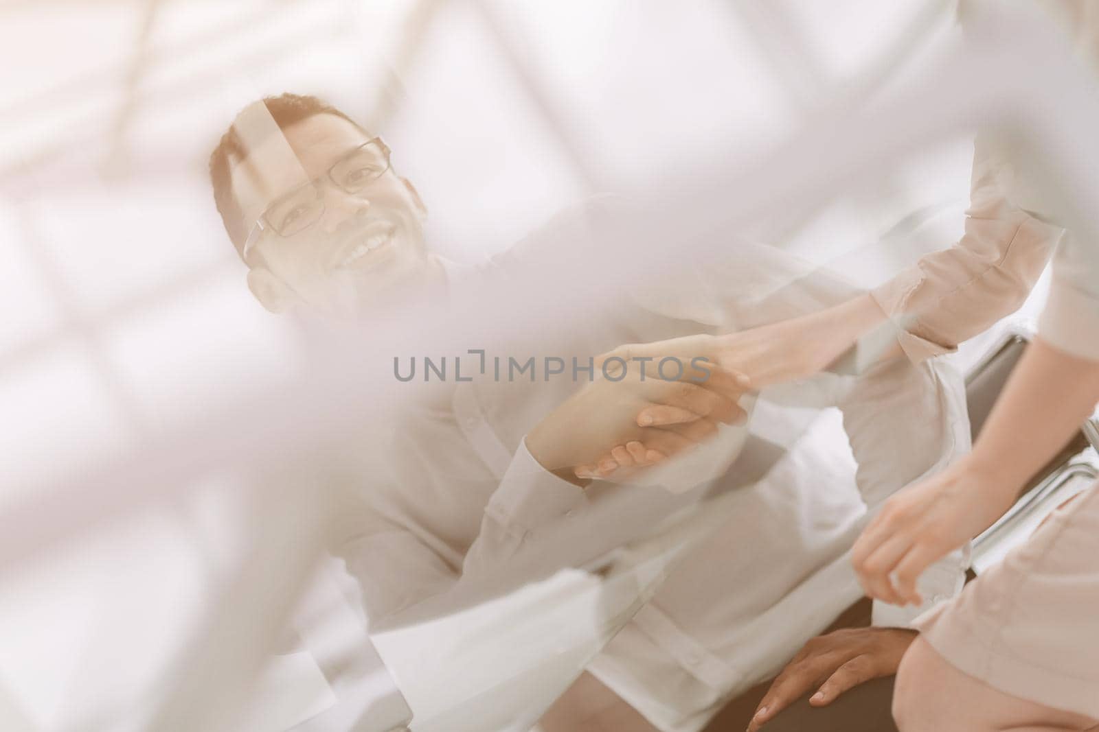 bottom view.handshake employees at the Desk in the office . photo with copy space