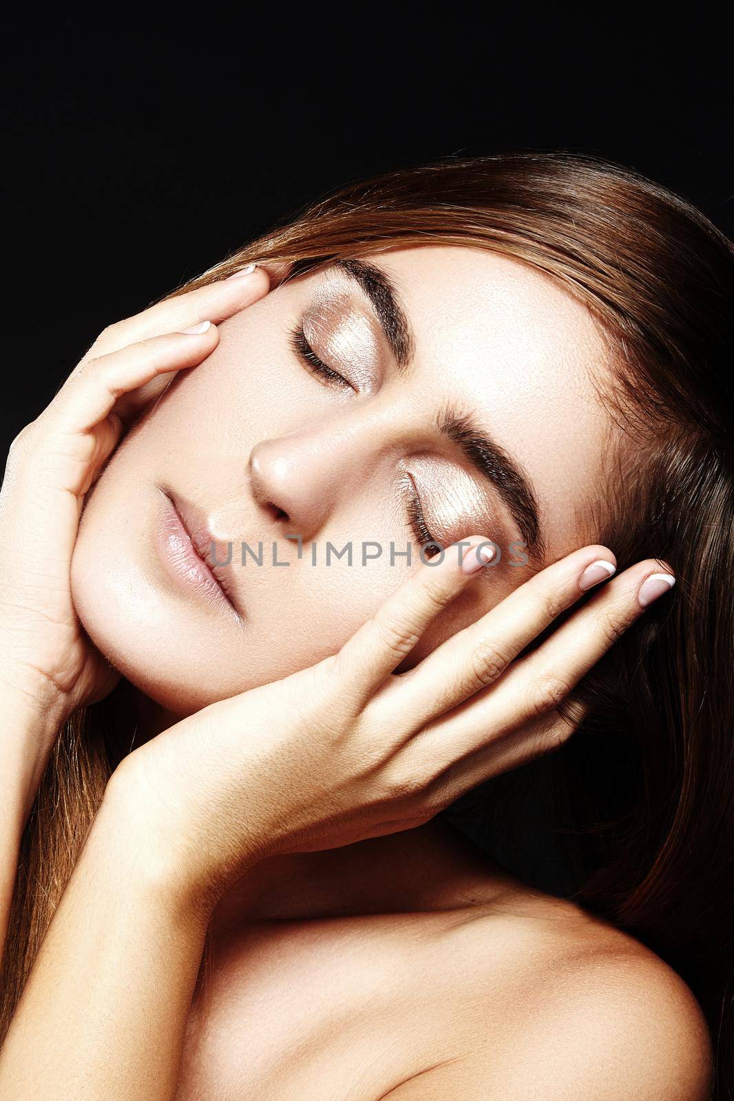 Closeup Portrait of Beautiful Woman face with Clean shiny Skin. on black background. Natural daily Makeup. Wellness Beauty shot, Spa Make-up.