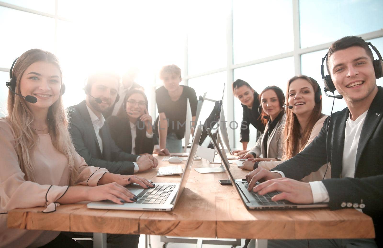 close up. group of mobile cellular operators sitting at a Desk