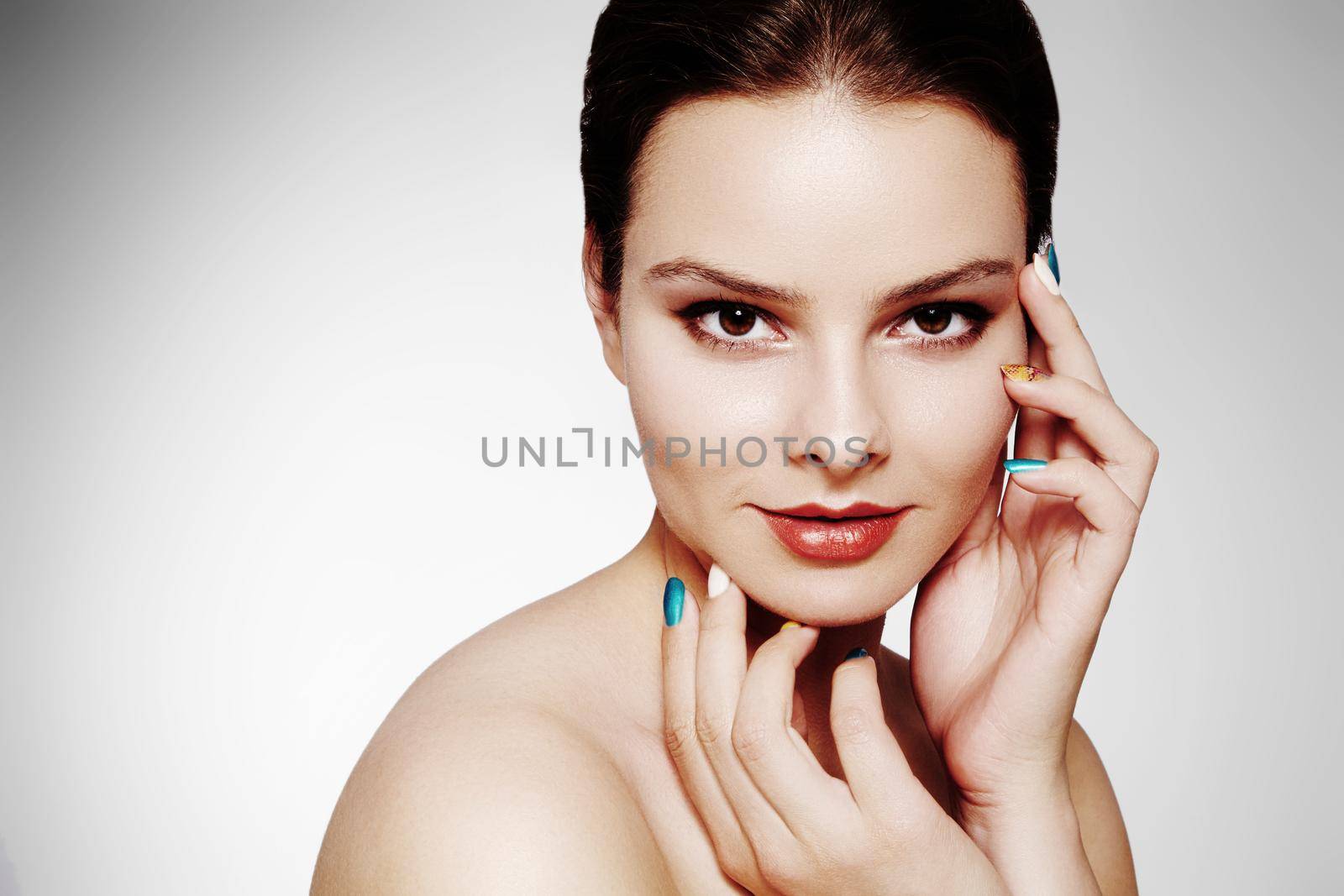 Beautiful model with fashion make-up. Close-up portrait sexy woman with glamour lip gloss makeup and bright eye shadows. Shot of celebrate visage, clean skin, lips with red lipstick, eyeshadows.
