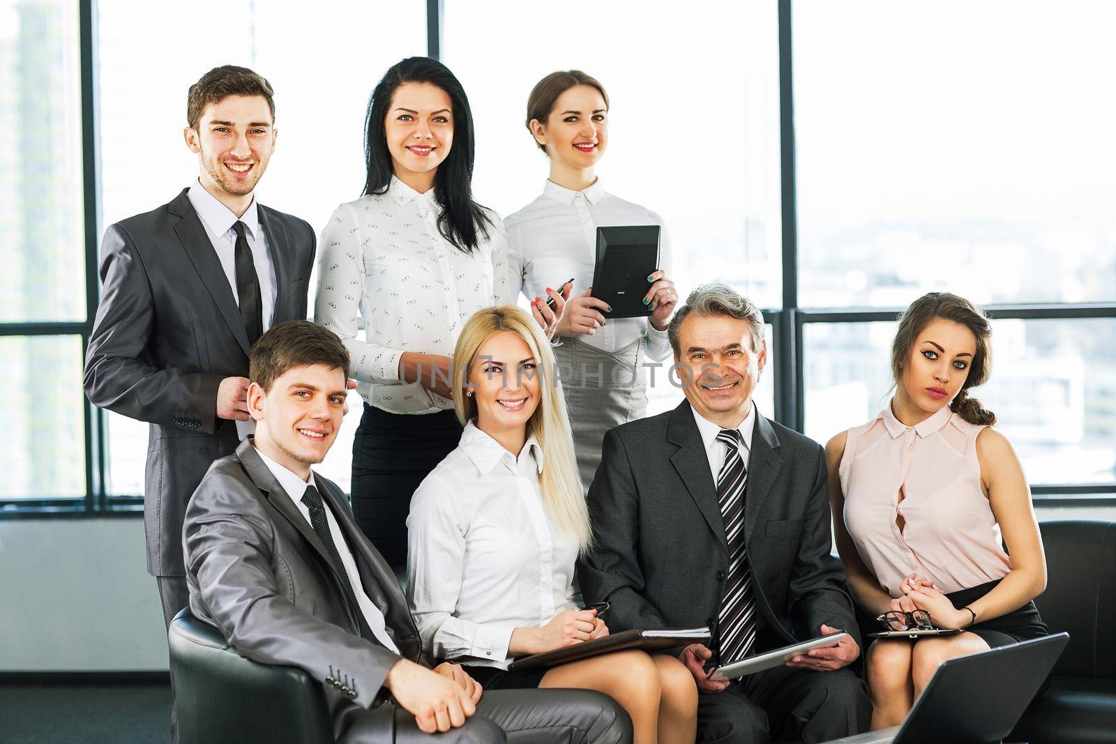 A group of businessmen discussing the policy of the company in the office.