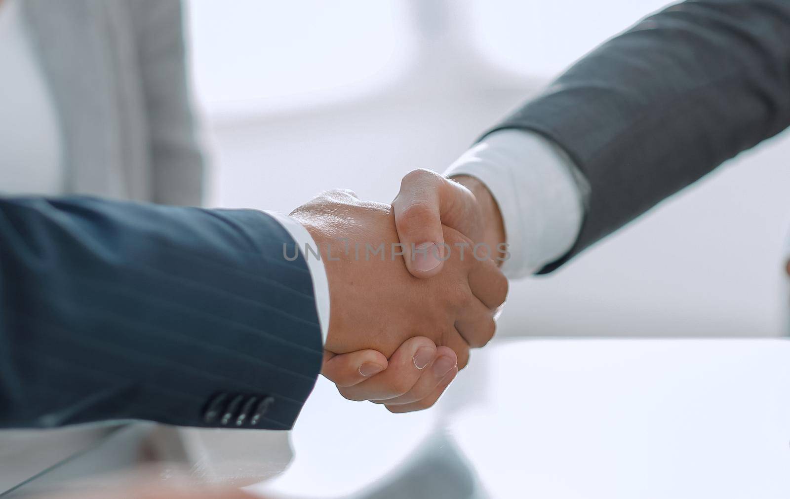 closeup.handshake of business partners after signing the contract.