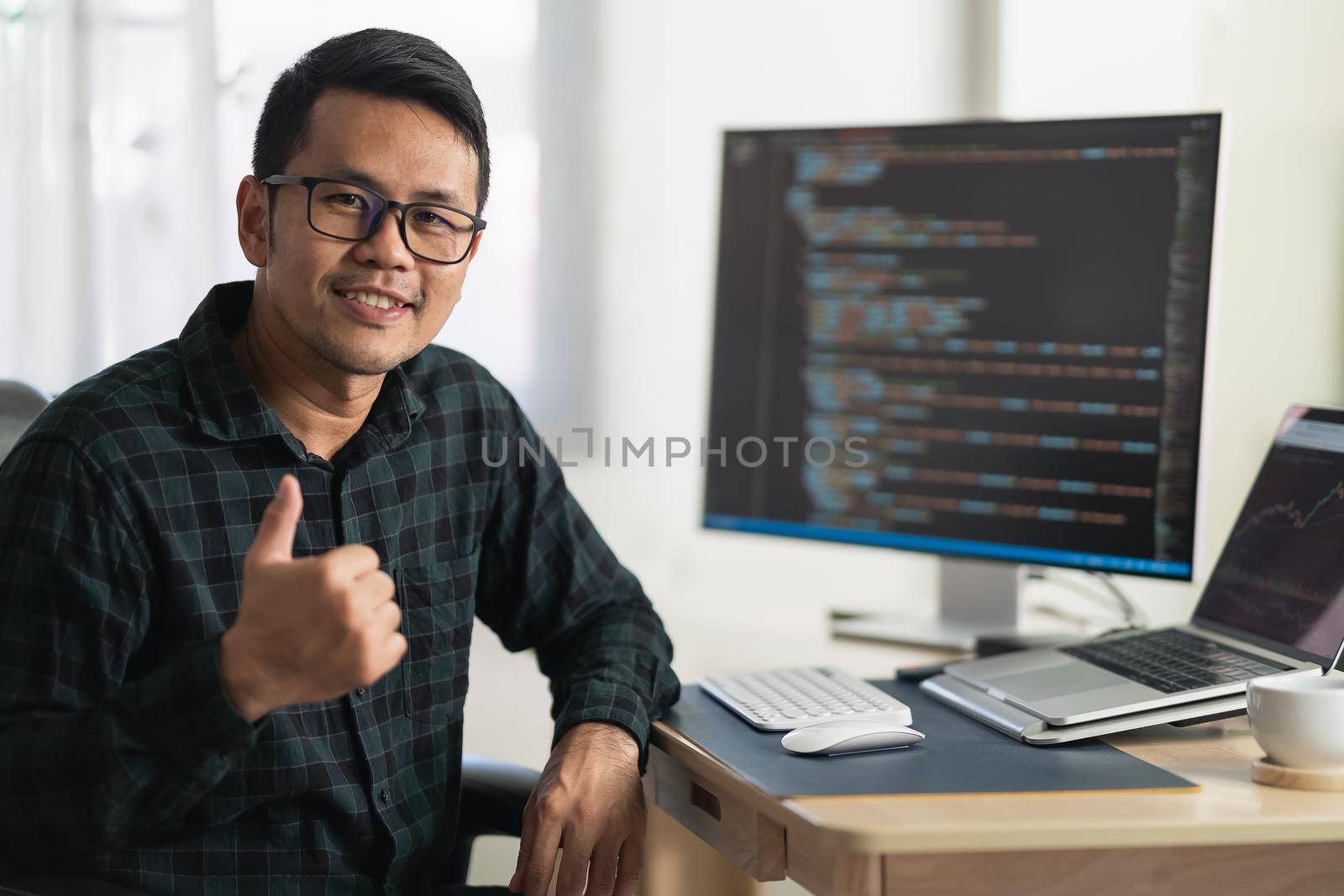 software develper working on laptop at home office. Programmer working develop web application. Software programming concept by Wmpix