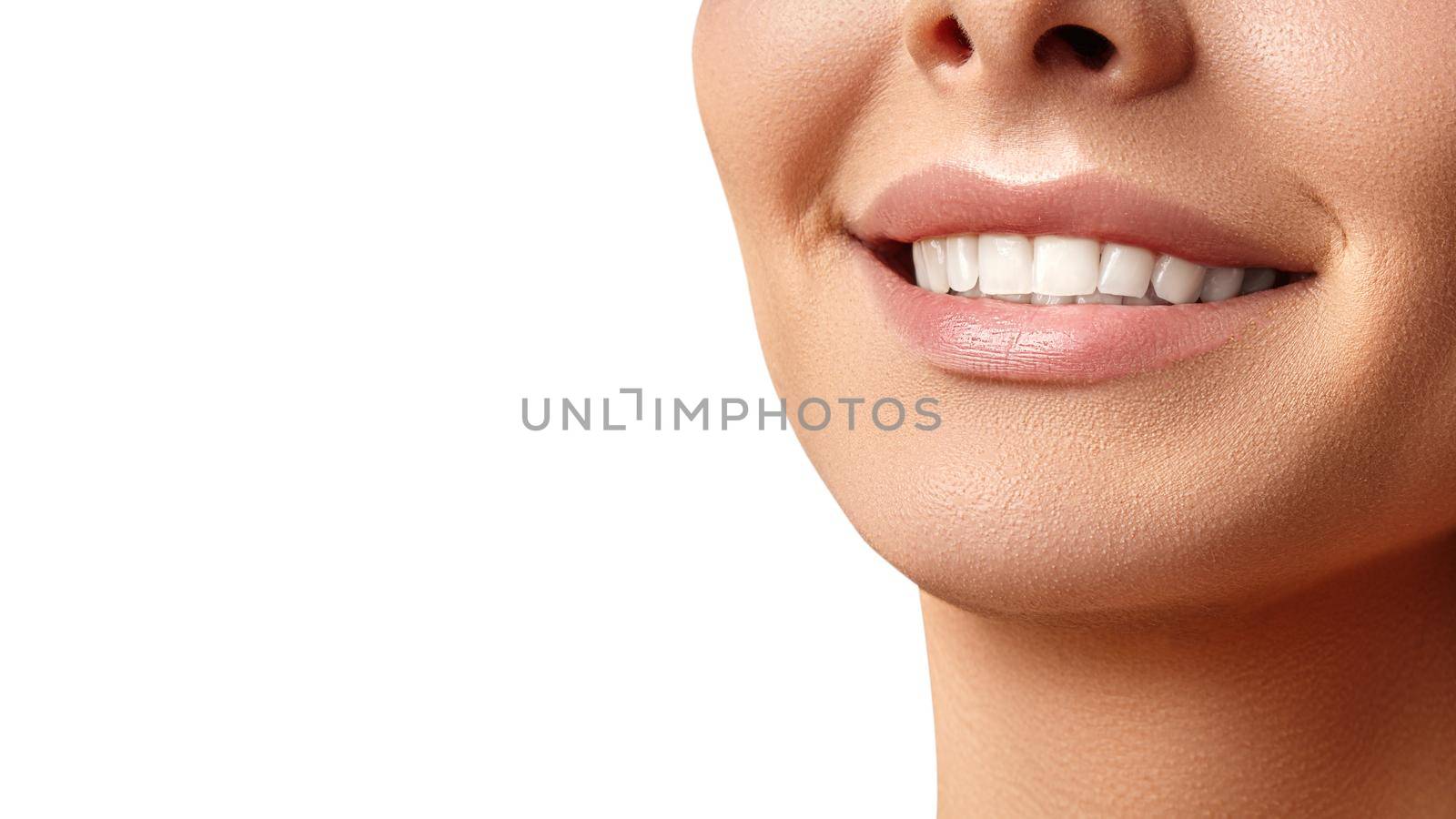 Wide smile of young beautiful woman with perfect healthy white teeth on grey background. Dental whitening, ortodont, care tooth and wellness. Natural makeup on perfect face.