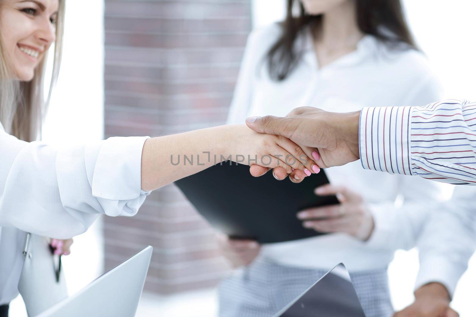 closeup.handshake business colleagues on the background of the office. by SmartPhotoLab