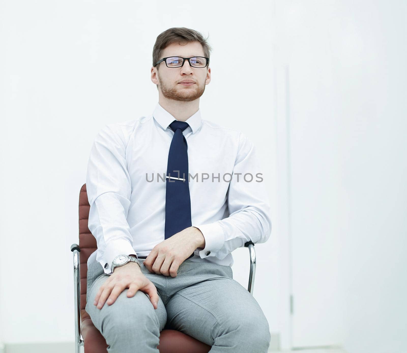 confident businessman sitting in a chair.photo with copy space