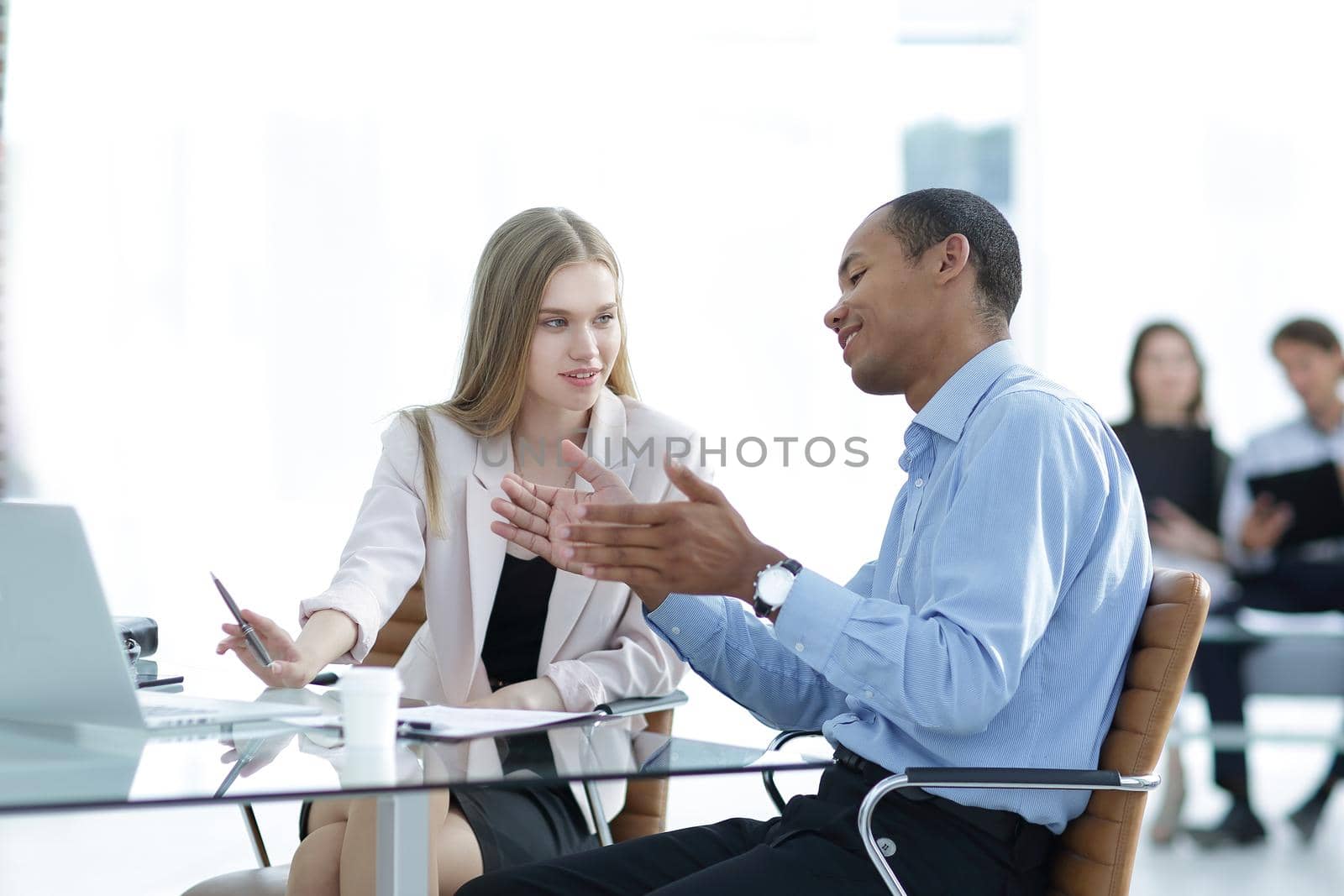 young business colleagues talking behind a Desk .photo with place for text