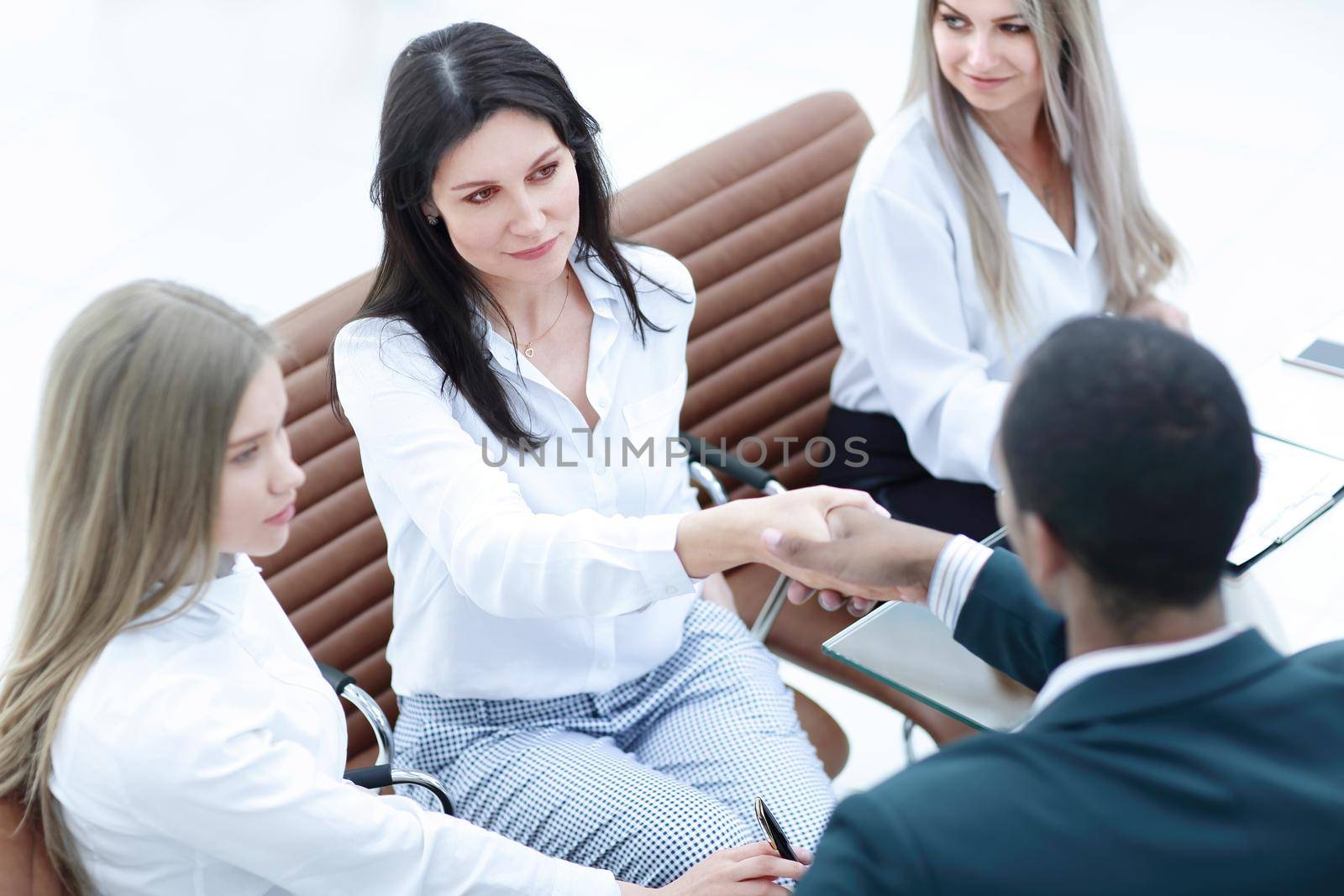 closeup.businesswoman shaking hands with partner at office meeting
