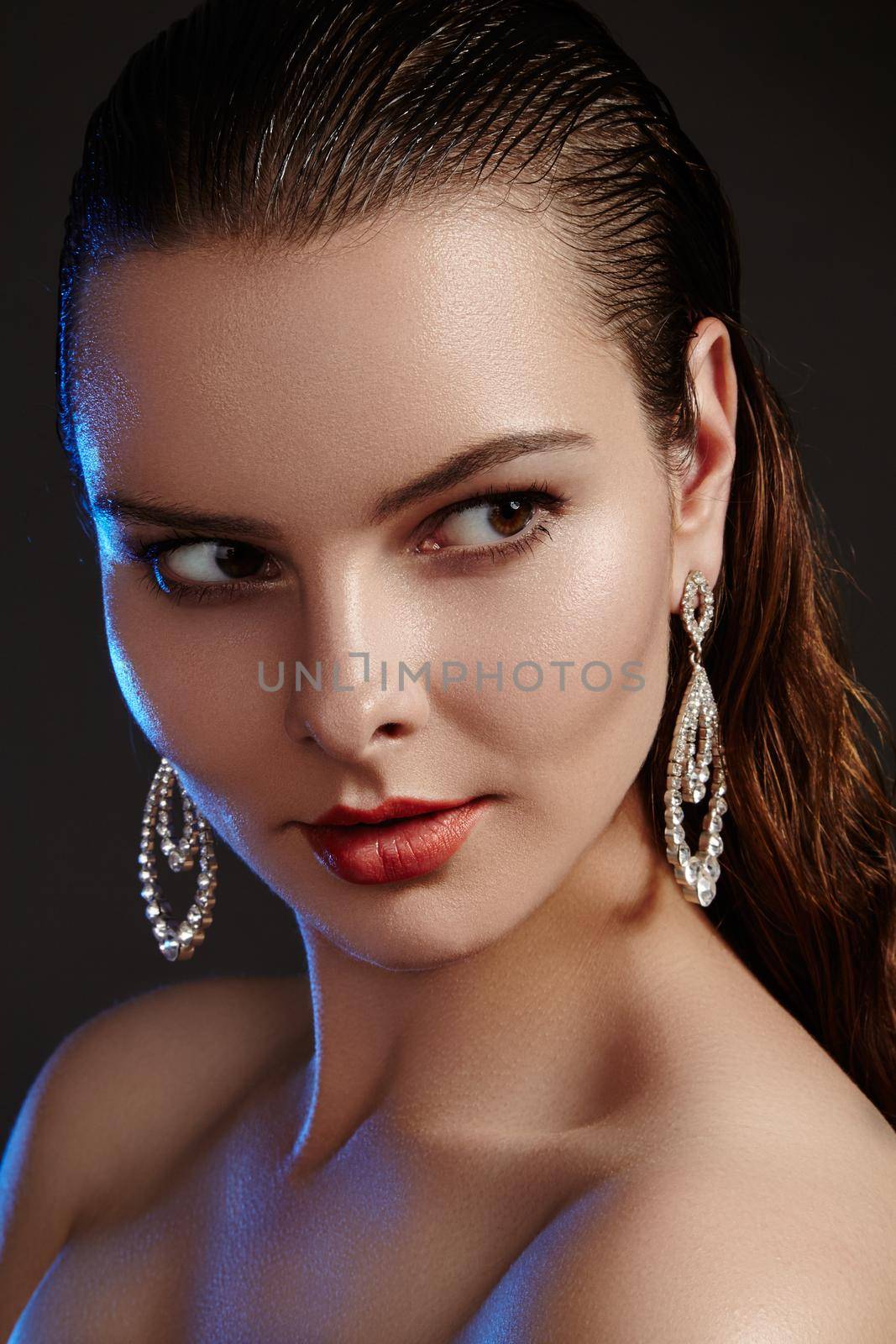 Beautiful woman in luxury fashion earrings. Diamond shiny jewelry with brilliants. Accessories jewelery, fashion makeup by MarinaFrost