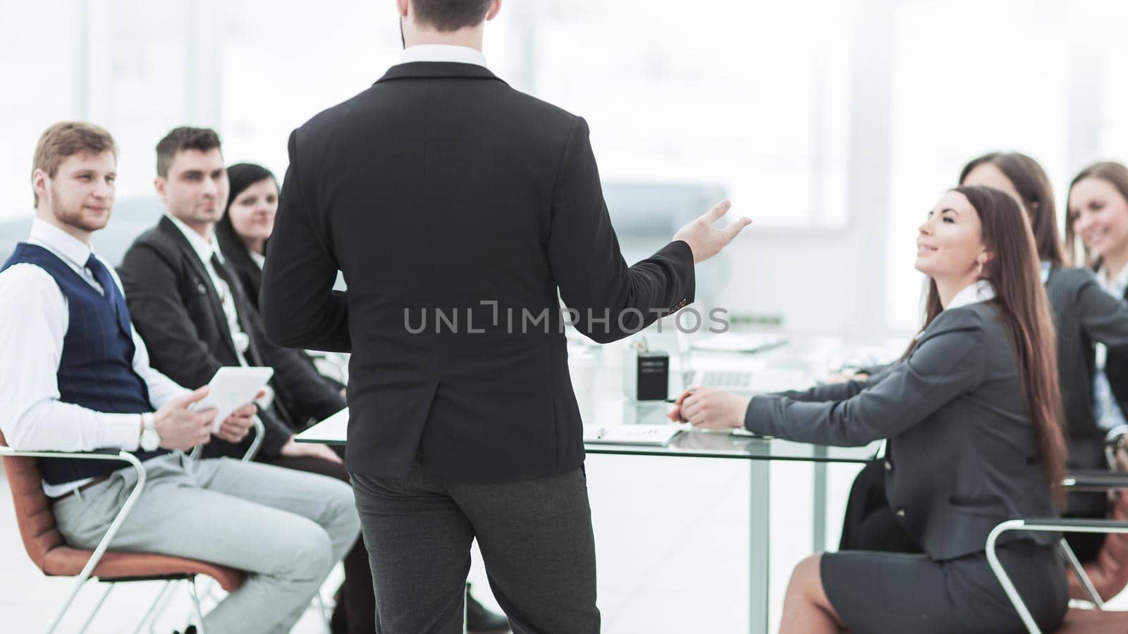 CEO speaks at the workshop business team in a modern office. the photo has a empty space for your text.