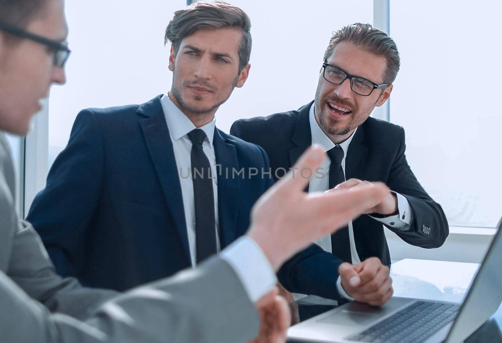 employees discussing the business plan sitting at the office Desk by asdf