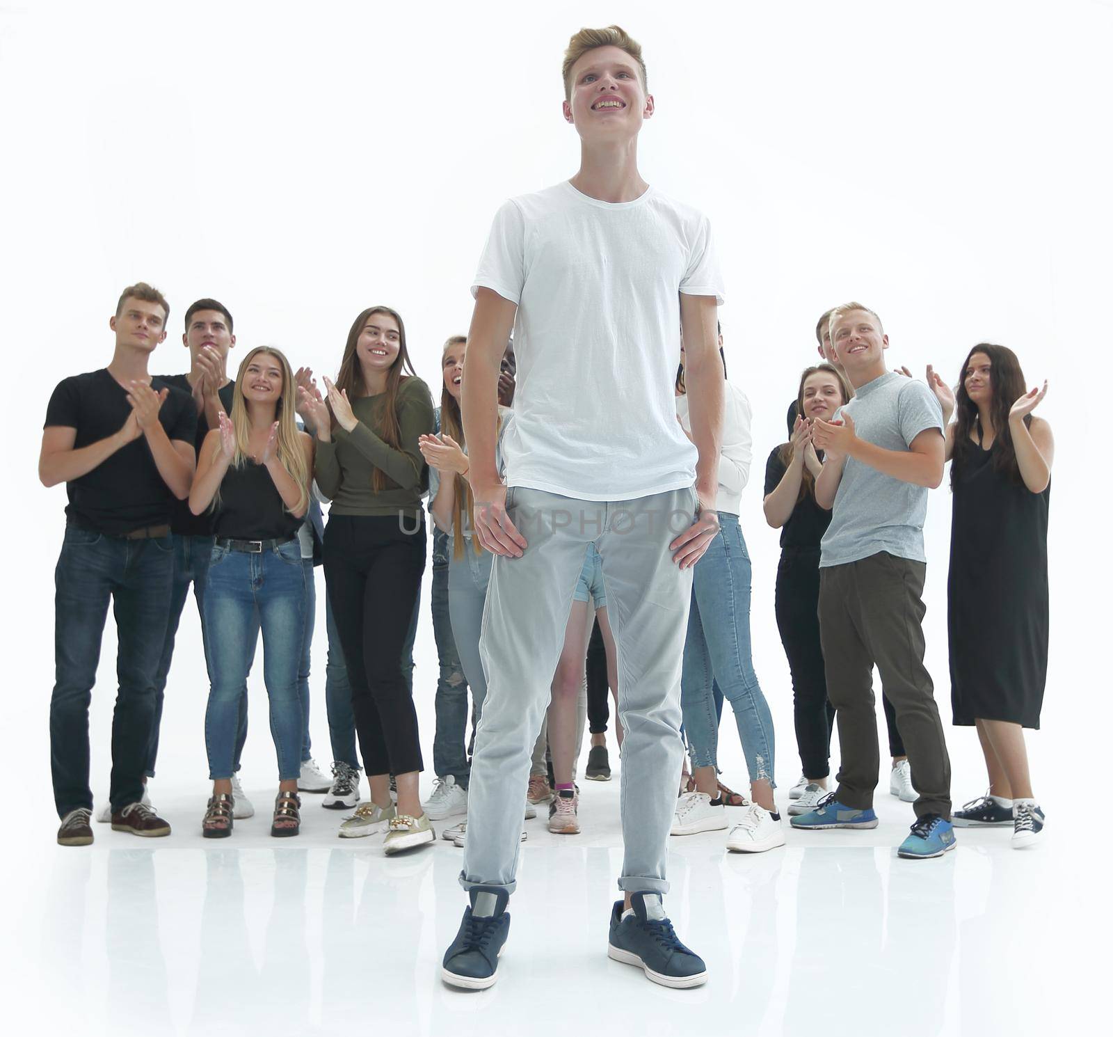 in full growth. casual guy standing in front of a group of diverse young people. photo with copy space
