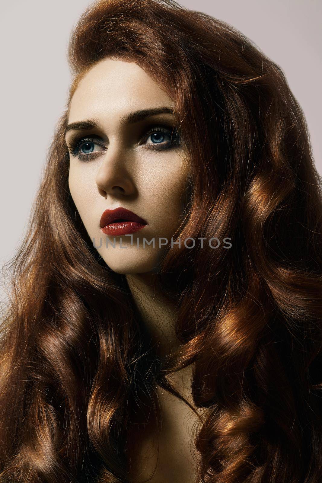 Beautiful ginger young woman with luxury hair style and fashion gloss makeup. Beauty closeup sexy model with red hair by MarinaFrost