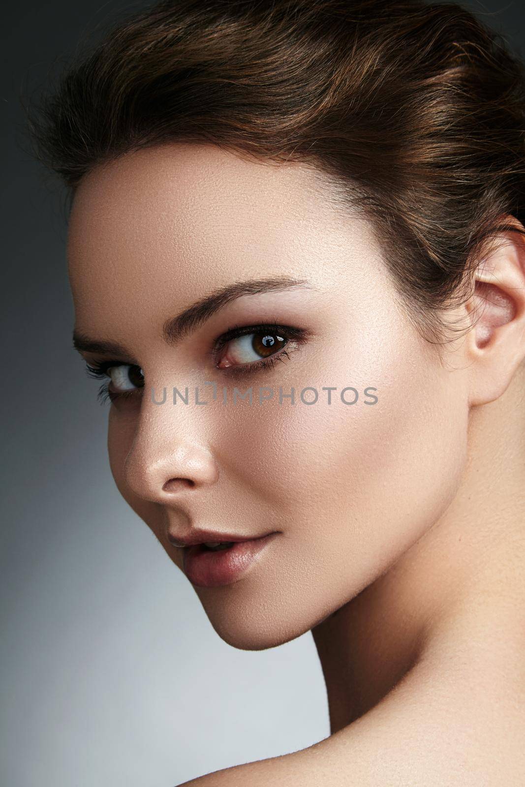 Beautiful face of young woman. Skincare, wellness, spa. Clean soft skin, healthy fresh look. Natural daily makeup.