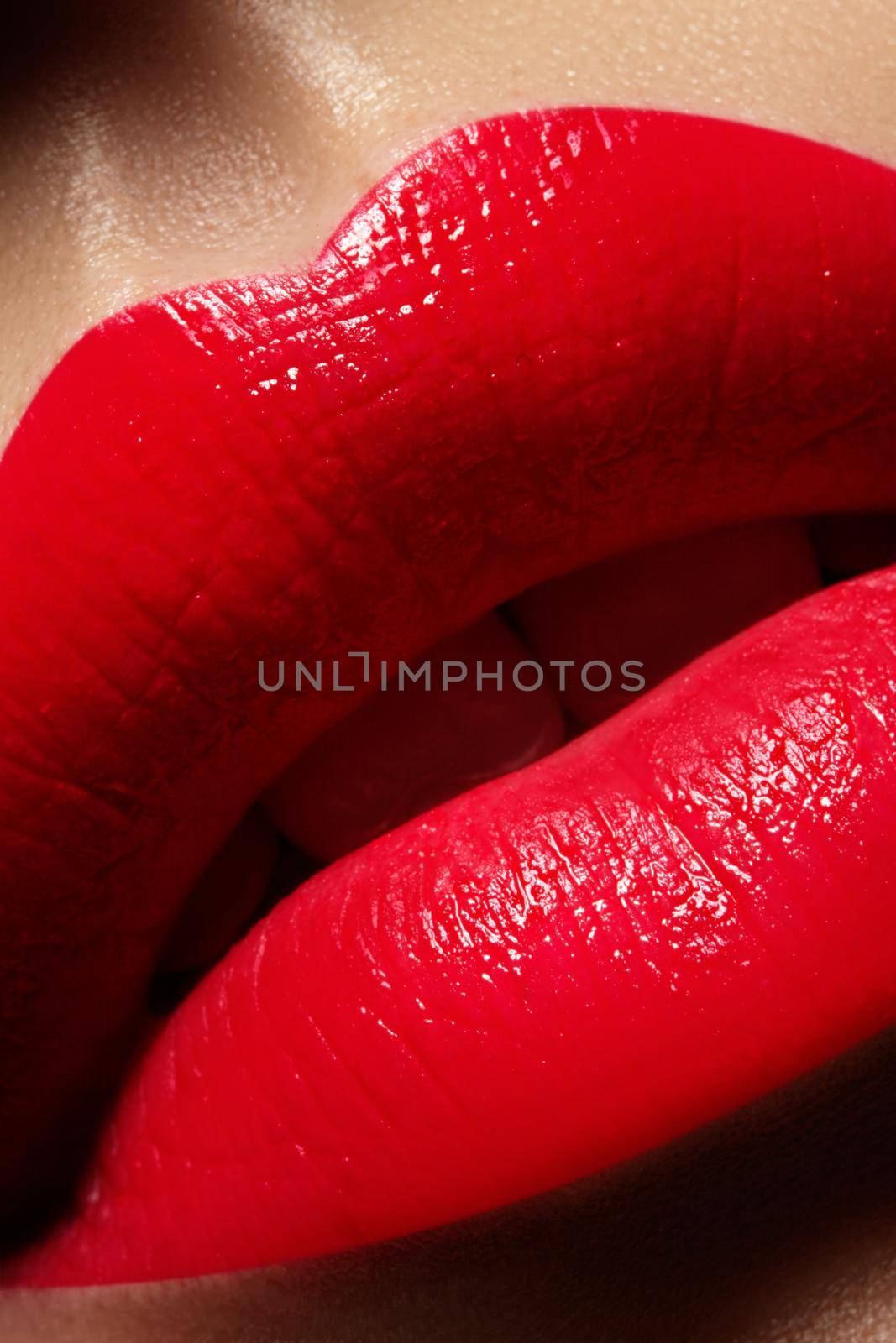 Beautiful female Lips. Sweet Kiss with red lipstick. Lip Make-up on macro shoot. Hot fashion lip makeup. Great for Valentines day