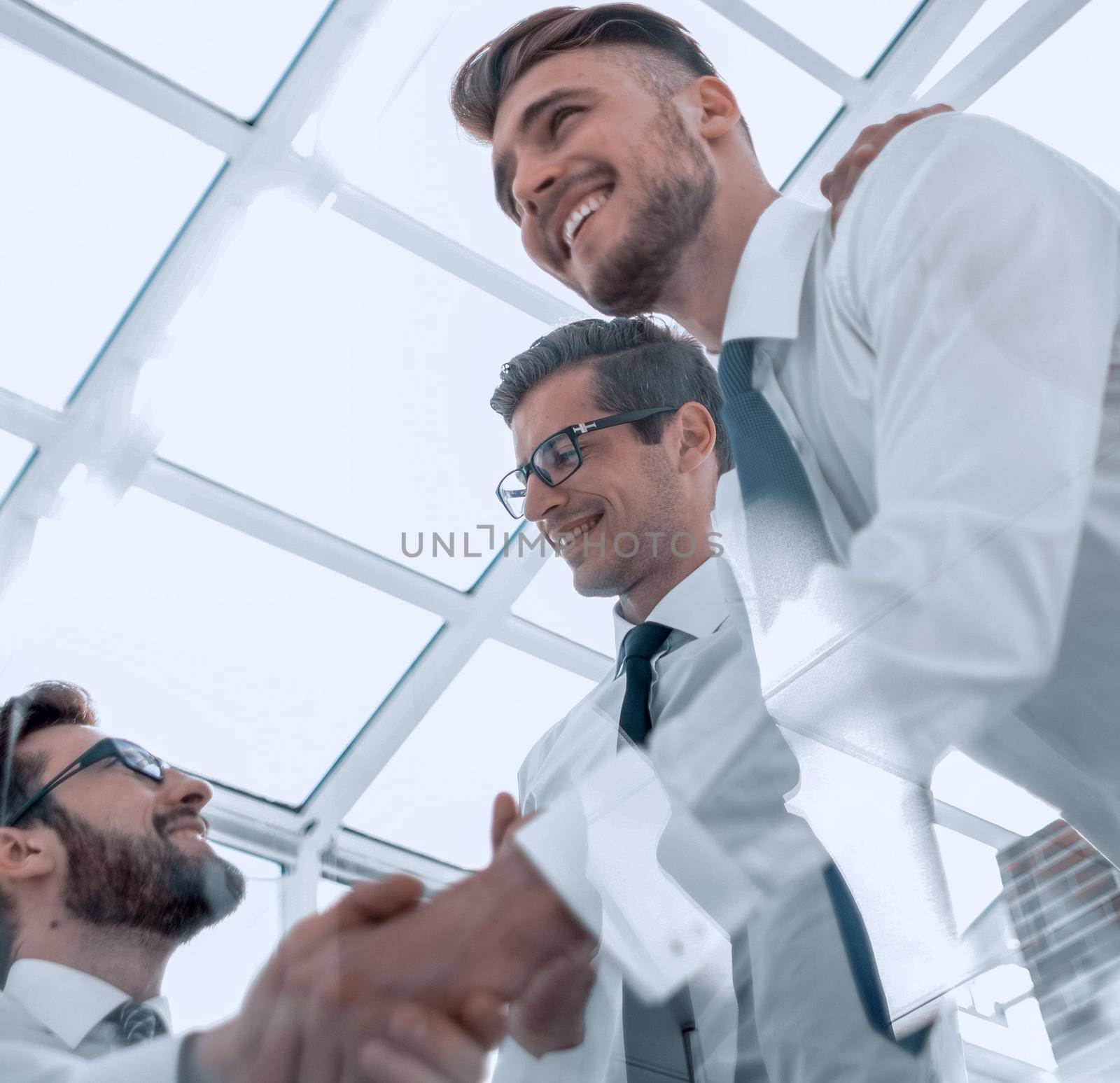 bottom view. handshake employees over the Desk by asdf