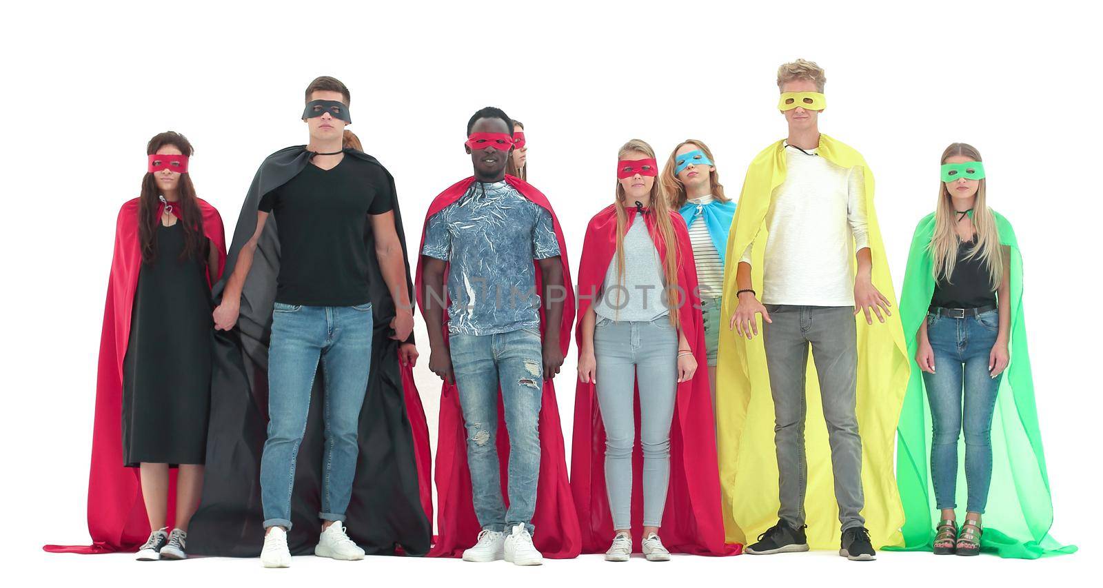 young people in colorful superhero cloaks standing together. by asdf