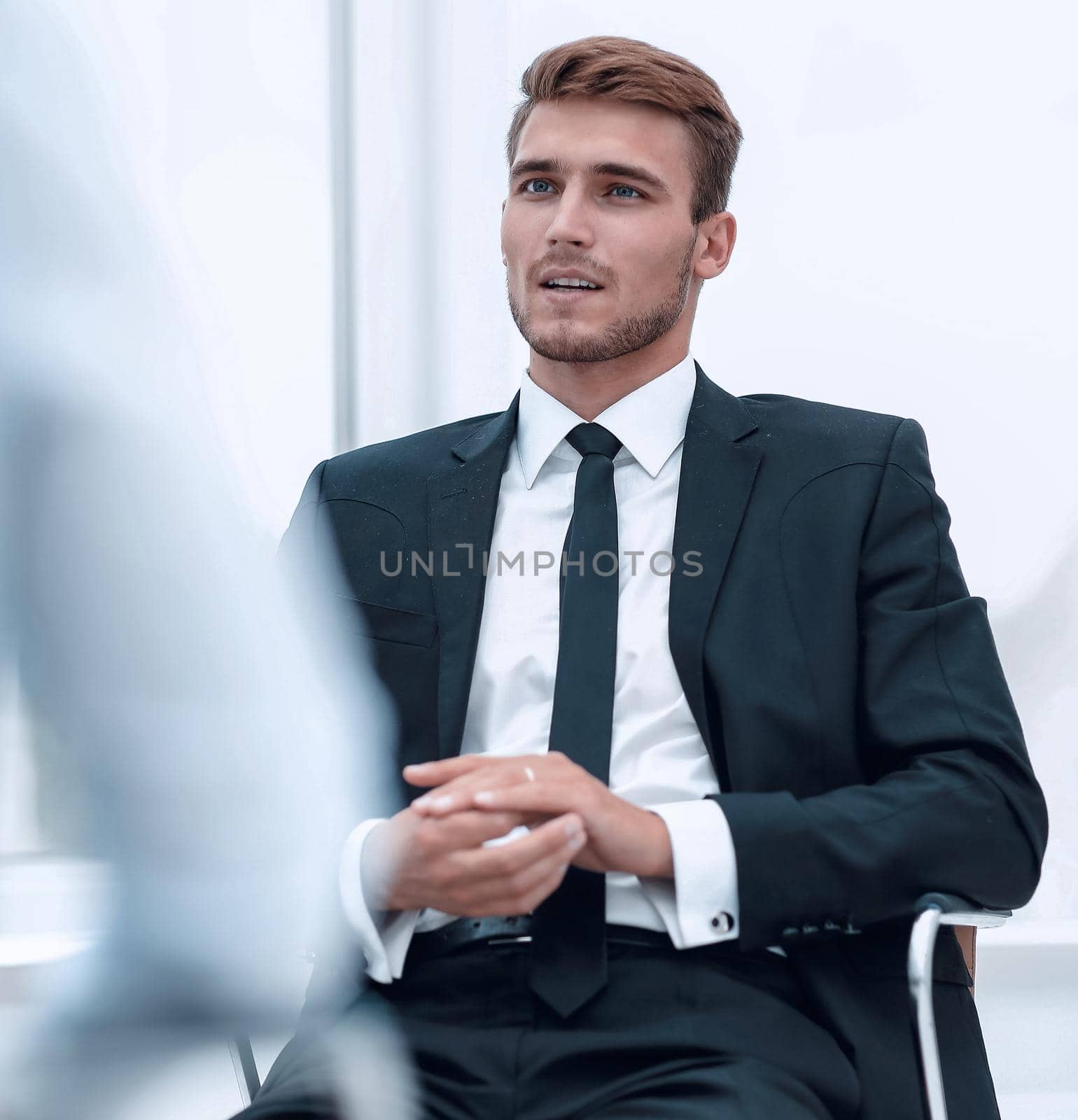 closeup . serious businessman sitting in an office chair. by asdf