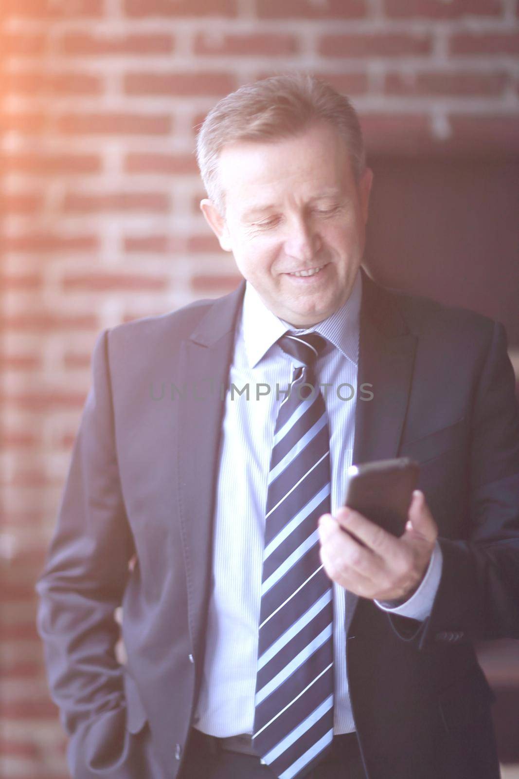 senior businessman reading text message on smartphone.people and technology