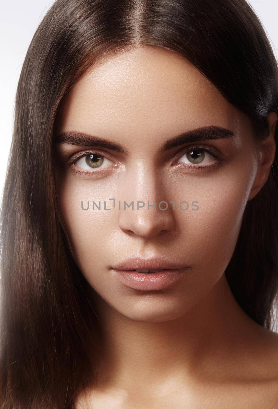 Beautiful face of young woman. Skincare, wellness, spa. Clean soft skin, healthy fresh look. Natural daily makeup.