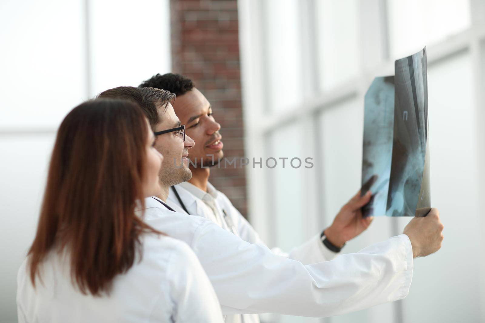 group of medical doctors discussing the patient's x-ray. the concept of health